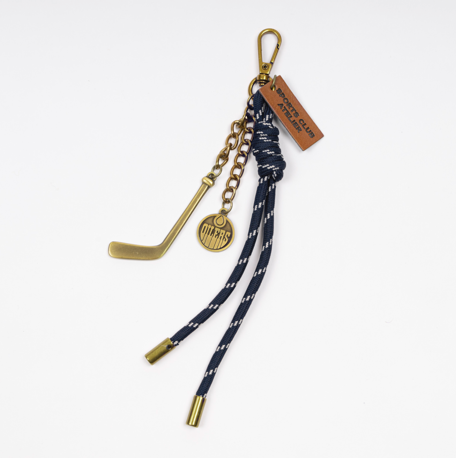 Bag clip keychain with Edmonton oilers logo, hockey stick, and blue cord wth gold details. metal alloy 